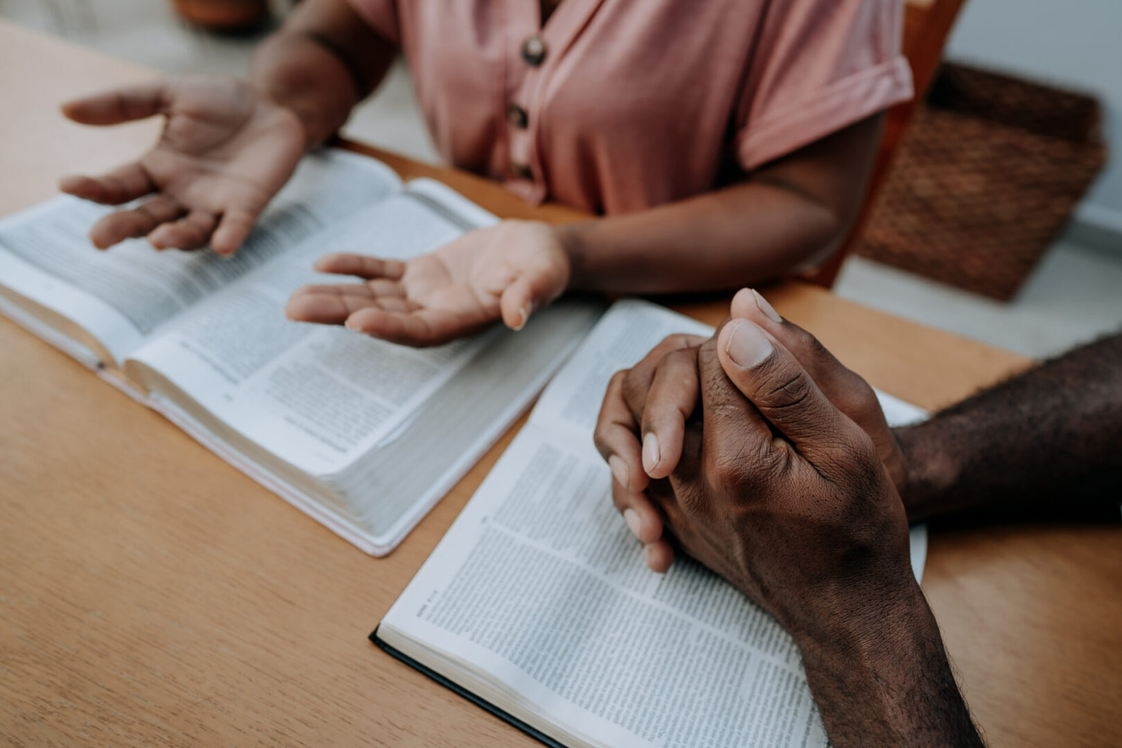 Two individuals reading and discussing text