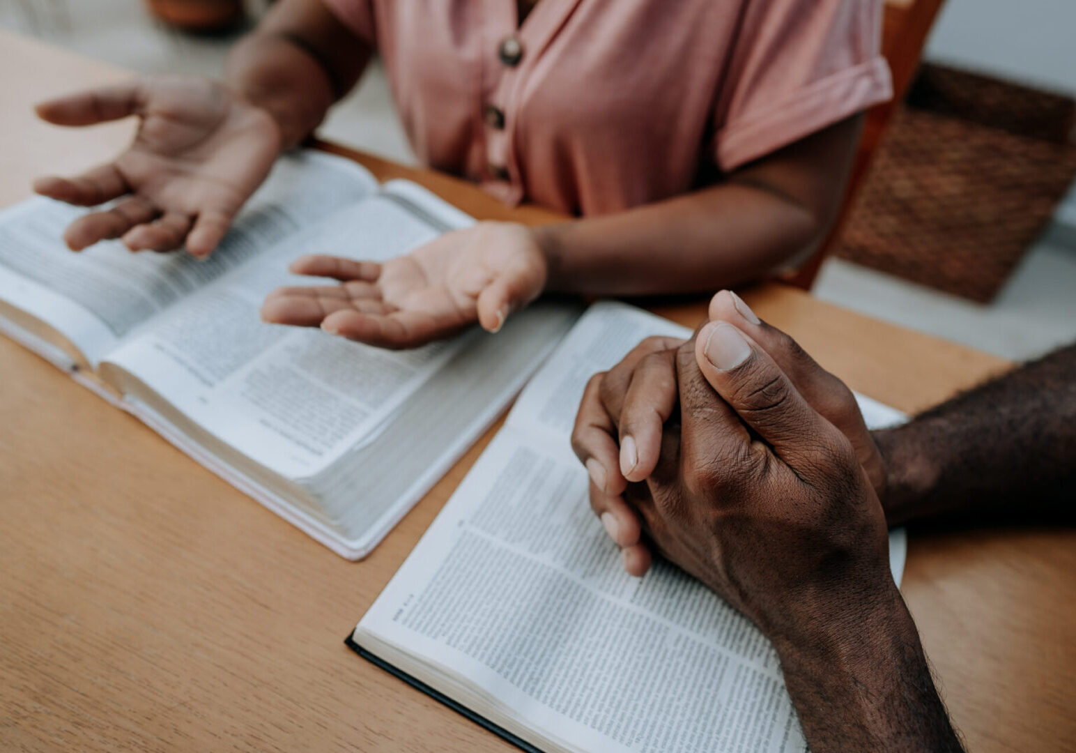 Two individuals reading and discussing text